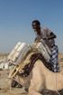 A man ties neatly-finished blocks of salt to a camel near Dallol in Ethiopia for transport to the nearest town. Once the camels travelled all the way to the highlands from here.