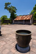 A large metal urn stands in a paved courtyard in the palace of Hue, Vietnam